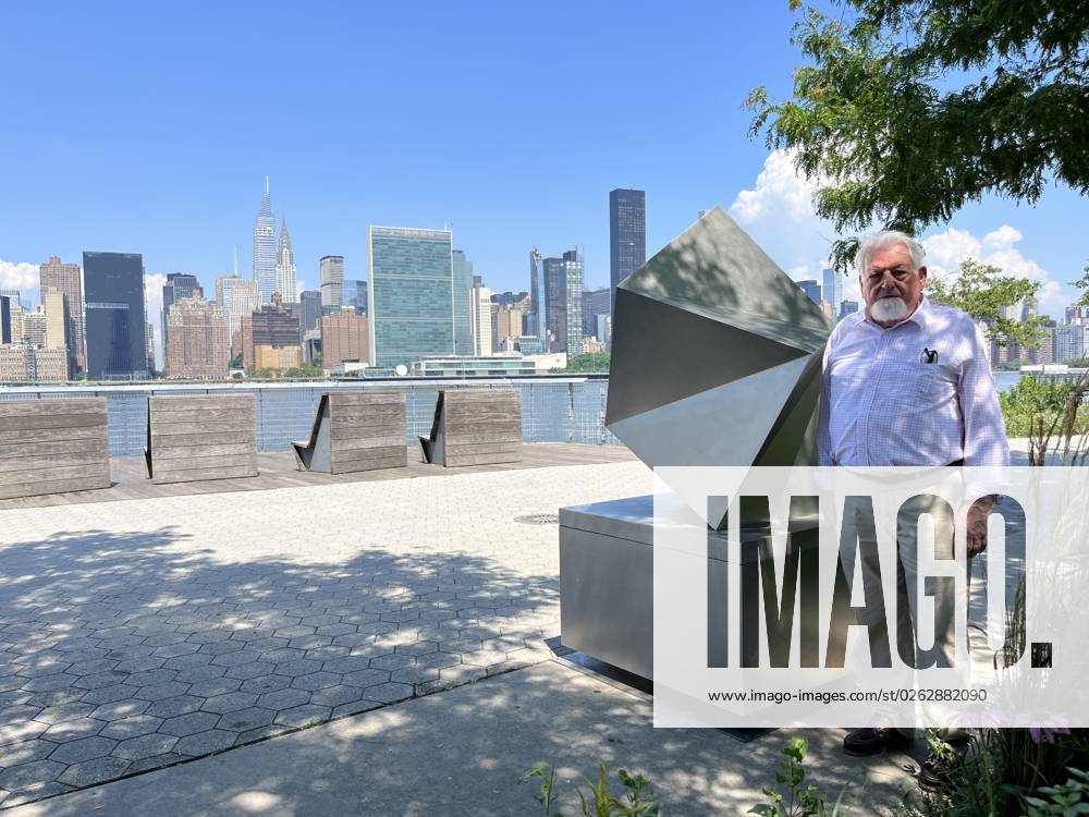 Spanish artist Manuel Ferreiro Badia poses during an interview with EFE next to his sculpture titled Compostela, a Fractal Study of a shell today at Hunters Point South Park in Queens, New York, USA 06 July 2023. A striking metallic sculpture by the Spanish artist Manuel Ferreiro Badia, inspired by origami and Galicia, his native land, stands from this Thursday in a privileged place in New York, in front of its famous skyscraper profile. A polyhedral sculpture by the Spaniard Ferreiro Badía stands before the New York skyline !ACHTUNG: NUR REDAKTIONELLE NUTZUNG!