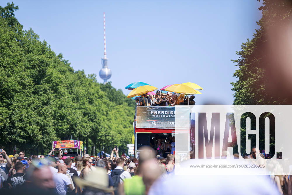 Rave the Planet 2023 Germany, Berlin on 08 July 2023 about 200 000 ravers and techno fans parade through the Tiergarten on the Starsse des 17 Juni on a hot summer day A young woman holds up a homemade sign that reads Love is the Answer