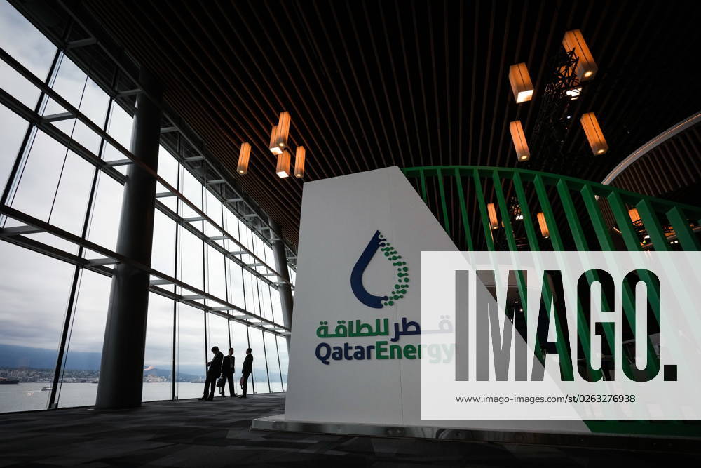 Delegates are silhouetted as they take in the view of the harbour while talking near the Qatar Energy booth during the LNG2023 conference, in Vancouver, B.C., Monday, July 10, 2023. VANCOUVER CANADA - ZUMAc35_ 20230710_zaf_c35_136