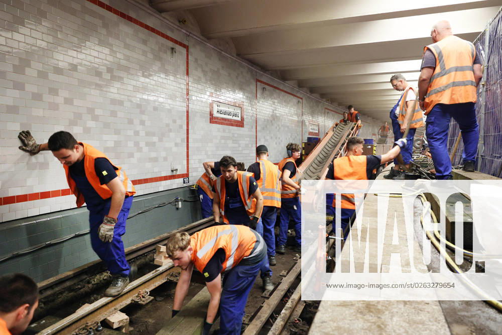Berlin Germany At the Alexanderplatz underground station, construction work is underway on the U2 track, which has been closed due to an accident Holes are drilled for planks, the straight line is measured and then the screws are tightened.