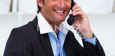 Close-up of a smiling businessman talking on phone in the office background,business,businessman,call,caucasian,cell,collar,communicate,communication,computer,concept,confident,conversation,corporate,desk,executive,expression,face,hand,handsome,holding,isolated,male,man,manager,mobile,modern,office,people,person,phone,portrait,power,professional,service,shirt,smiling,speaking,studio,success,suit,support,talking,team,telephone,tie,white,work,worker