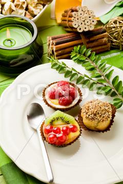 Photo of delicious dessert plate with italian fruits pastries cakes, pastry, cake, candy, dessert, black currant, kiwi, raspberries, cream puffs, stuffed, sugar, cannoli, chocolate, candies, catering, spoon, kitchen, fruit, italian, italian, tasty, gourmet, pies, cream, candle, leaves, decoration, fire, table, food, restaurant