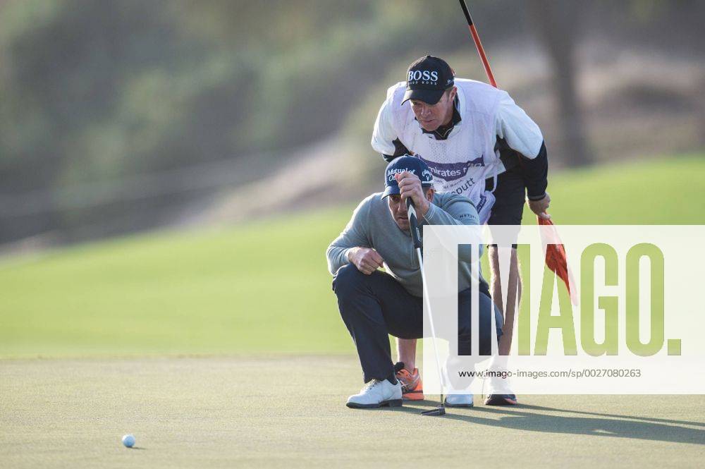 Henrik Stenson of Sweden and his caddy line up a putt in their second round during the PGA Golf Herren European Tour Dubai Desert Classic Tournament Day 3 at the Emirates Golf Club, Dubai, UAE on 4 February 2017.