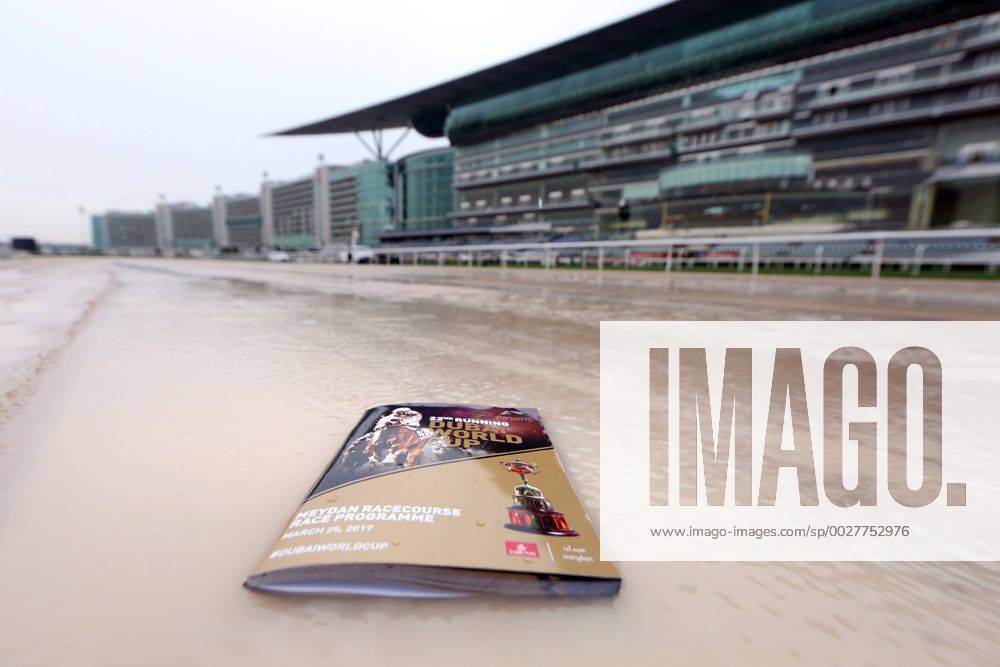 - SPORT 25.03.2017, Dubai, UAE, VEREINIGTE ARABISCHE EMIRATE - Racecard lies on the flooded dirt track. Meydan racecourse. (Rennprogramm, Programmheft, Dirttrack, Sandbahn, ueberflutet, Regen, Regenwetter, regnerisch, Schlechtwetter, Tribuene, Tribüne) 170325D505MEYDAN