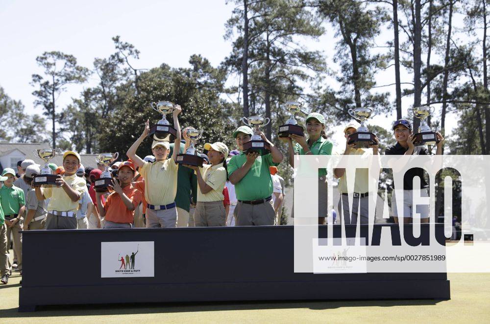 The winners from all age groups of the Drive, Chip & Putt Championship raise their trophies at the trophy ceremony at the 2017 Masters Tournament at Augusta National Golf Club in Augusta, Georgia on April 2, 2017. AUG20170402120 JOHNxANGELILLO