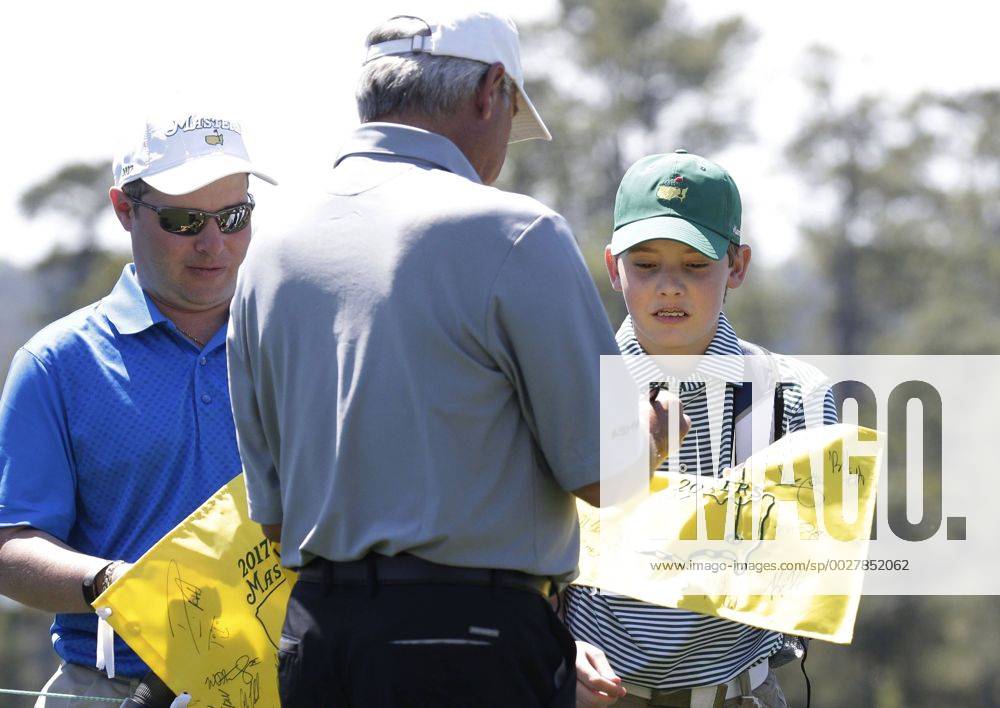 Fredie Couples signs a Masters flag for a fan while playing a practice round at the 2017 Masters Tournament at Augusta National Golf Club in Augusta, Georgia on April 2, 2017. AUG20170402104 JOHNxANGELILLO
