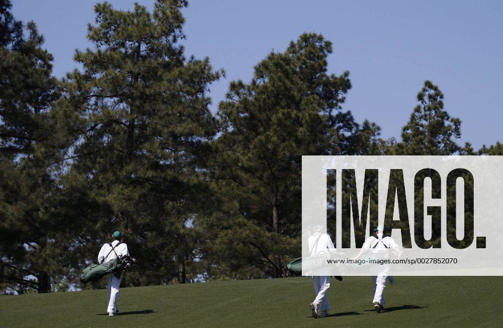 Three caddies walk up the first hole fairway at a practice round at the 2017 Masters Tournament at Augusta National Golf Club in Augusta, Georgia on April 2, 2017. AUG20170402113 JOHNxANGELILLO