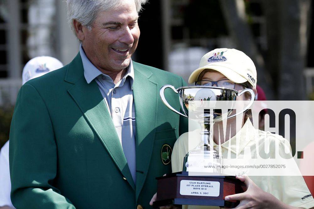 Freddie Couples watches Liam Hartling overall winner of the Boys 10-11 age group in the Drive, Chip & Putt Championship hold his trophy at the 2017 Masters Tournament at Augusta National Golf Club in Augusta, Georgia on April 2, 2017. AUG20170402118 JOHNxANGELILLO