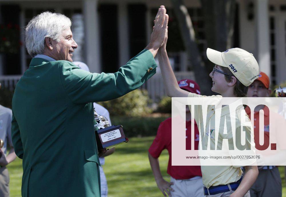 Freddie Couples high fives Liam Hartling who is the overall winner of the Boys 10-11 age group in the Drive, Chip & Putt Championship at the 2017 Masters Tournament at Augusta National Golf Club in Augusta, Georgia on April 2, 2017. AUG20170402119 JOHNxANGELILLO