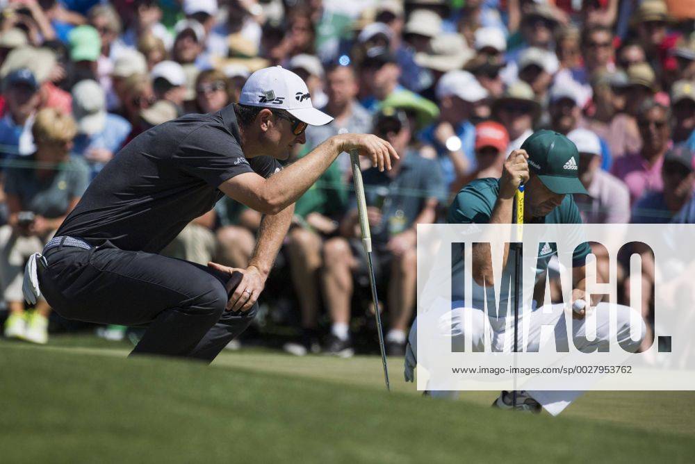 Justin Rose (L) and Sergio Garcia line up putts on the fourth green during the fourth round of the 2017 Masters Tournament at Augusta National Golf Club in Augusta, Georgia on April 9, 2017. AUG20170409317 KEVINxDIETSCH