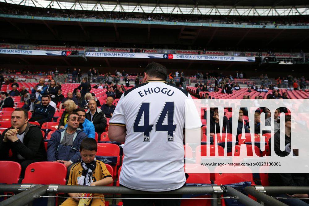 April 22nd 2017, Wembley Stadium, London England; Emirates FA Cup semi-final Chelsea versus Tottenham Hotspur; Spurs fan wearing home shirt with Ugo Ehiogu on the back in Tribute on the big screen outside Wembley Stadium to former Aston Villa and England International Ugo Ehiogu who passed away yesterday PatrickxFletcherx ActionPlus11870749