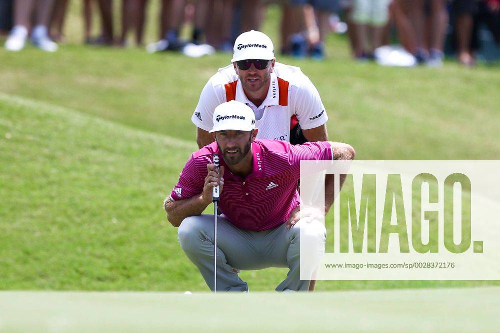Ponte Vedra Beach, Florida, United States - Dustin Johnson (bottom) and his caddie Austin Johnson line up a putt on the 9th green during the second round of The PLAYERS Championship at TPC Sawgrass. Golf 2017: The PLAYERS Championship - Round 2 - ZUMAw109 20170512_zap_w109_006