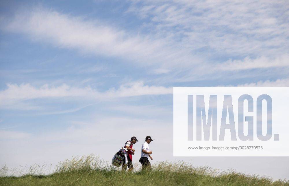 Xander Schauffele and his caddie Austin Kaiser walk on the 8th fairway during round 2 of the 117th U.S. Open golf tournament at Erin Hill golf course in Erin, Wisconsin on June 16, 2017. WIS20170616329 KEVINxDIETSCH