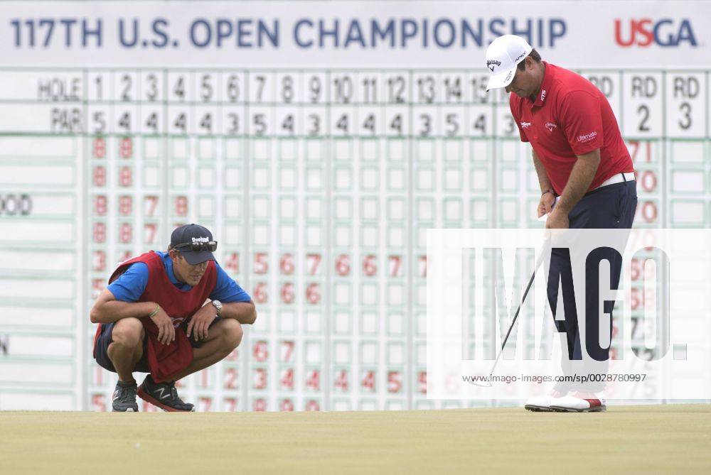 Patrick Reed and his caddie Kessler Karain line up a putt on the 18th green during round 3 of the 117th U.S. Open golf tournament at Erin Hill golf course on June 17, 2017 in Erin, Wisconsin. WIS20170617305 KEVINxDIETSCH