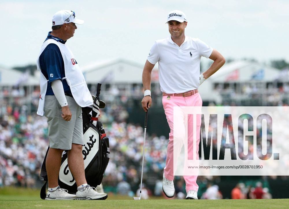 Justin Thomas (R) talks with his caddie as he waits for the group ahead on the 10th fairway during round 3 of the 117th U.S. Open golf tournament at Erin Hill golf course on June 17, 2017 in Erin, Wisconsin. WIS20170617104 BRIANxKERSEY