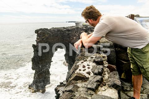 Man at the Holei Sea Arch, Hawaii Volcanoes National Park {Holei,Sea,Archhole,waterscape,man,arch,cliff,coast,hawaii,island,landscape,lava,nature,ocean,pacific,park,usa,volcano,wave,america,froth,geology,hilo,kilauea,shore,shoreline,big,volcanoes,national,flow,national park,polynesia,united,states,craters,rock,chain,natural,tropical,white,bigisland,cave,colorful,edge}