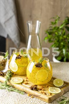 Homemade fruit tea with sea buckthorn, lime, rosemary, star anise and chia seeds for autumn and winter holidays - festive Christmas, Thanksgiving drinks. Healthy food life. tea, drink, fruit, christmas, punch, beverage, sweet, glass, food, healthy, cocktail, background, alcohol, juice, orange, cup, wooden, liquid, hot, mint, yellow, autumn, fresh, table, winter, warm, wine, anise, cinnamon, lemon, red, refreshment, spice, closeup, rustic, grog, ice, water, berry, cold, fall, homemade, summer, seasonal, soda, honey, leaf, lemonade, mug, sangria