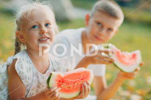 Funny little toddler kids brother and sister eating watermelon on the park. Happy boy and girl together. Childhood, Family, Healthy Diet Concept girl, brother, sister, watermelon, fruit, healthy, grass, boy, green, family, eating, childhood, home, children, little, garden, pool, inflatable, kids, toddler, eat, food, happy, person, park, slice, sweet, together, lawn, red, fun, snack, juicy, caucasian, nature, nutrition, melon, happiness, friend, tasty, kid, enjoy, outdoors, water melon, smile, picnic
