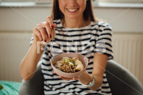 A shot of a girl holding plate bowl with a tasty smoothie made with banana and kiwi. abstract, aesthetic, art, background, banana, bowl, breakfast, chia, colorful, concept, contemporary, creative, delicious, design, dessert, detox, diet, fashion, food, fresh, fruit, granola, green, healthy, hipster, idea, kiwi, lifestyle, lunch, minimal, modern, oatmeal, organic, pastel, pattern, pudding, raw, seed, spoon, still, tasty, trend, vegan, vegetarian, visual, yellow, yogurt
