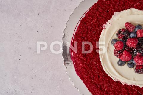 A top view of red velvet cake with raspberries, blueberries, and blackberries red velvet cake, red, velvet, cake, raspberries, blueberries, blackberries, top, view, berry, blueberry, blackberry, raspberry, dessert, food, fruit, homemade, sweet, tasty, delicious, fresh, gourmet, cream, sugar, pastry, bakery, eat, horizontal, decorate, frosting, table, birthday, party, celebrate, menu, concept, celebration, baked, decoration, stylish, detail