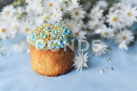 Orthodox Easter cake decorated with beads and daisies in the blue background april, background, baked, bakery, beads, blue, bread, breakfast, brioche, cake, candy, celebrate, celebration, chamomile, colorful, culture, daisies, decor, decorated, decoration, dessert, easter, egg, eggs, flower, food, fresh, frosting, fruit, gourmet, green, holiday, icing, meal, orthodox, pastry, pearl, pie, raisin, religion, Russian, sugar, sweet, table, tradition, traditional, ukrainian, white, yellow
