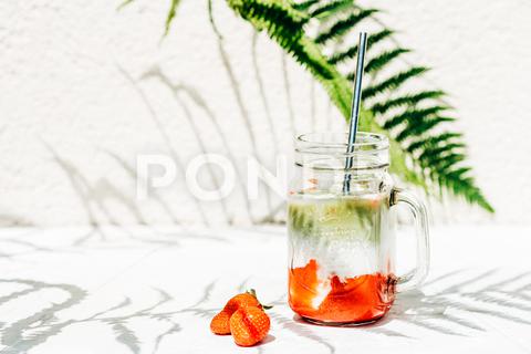 Mug with a cold drink of strawberries, matcha and milk and ingredients strawberry matcha latte, beverage, cocktail, cold, cool, drink, fresh, fruit, glass, green, herb, ice, ingredient, juice, leaf, lemonade, lime, mint, refreshing, tropical, sweet, soda, sun, sunlight, tonic, closeup, detox, diet, food, freshness, healthy, homemade, iced, liquid, natural, organic, refreshment, shake, table, summertime, party, strawberry, matcha, milkshake, milk, smoothie, straw