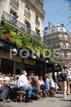 PARIS, FRANCE - Apr 24, 2008: People sitting densely packed in garden of famous Cafe de Flore in Paris, France city, urban, capital, france, french, cafe, bistro, famous, tourism, travel destination, garden, restaurant, cafe de flore, people, sitting, drinking, eating, densley packed