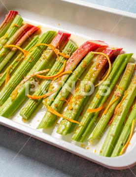 A closeup shot of rhubarb stalks in a rectangle plate. closeup, rhubarb, stalks, stems, food, fresh, vegetarian, organic, meal, dish, dinner, cuisine, delicious, prepared, healthy, plant, vitamin, ingredient, edible, green, species, colors, cooking
