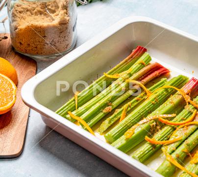 A closeup shot of rhubarb stalks in a rectangle plate. closeup, rhubarb, stalks, stems, food, fresh, vegetarian, organic, cooked, meal, dish, dinner, cuisine, delicious, prepared, healthy, plant, vitamin, ingredient, edible, green, species, colors