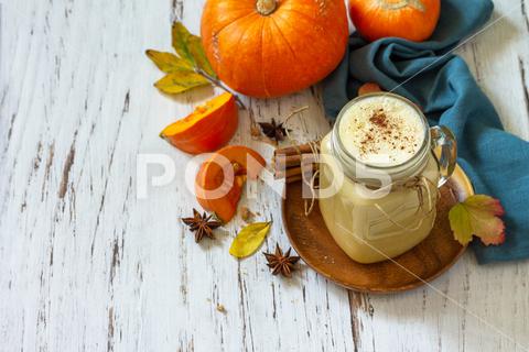Autumn drink. Pumpkin spiced latte or coffee in glass on a rustic wooden table. Copy space. pumpkin, thanksgiving, autumn, coffee, latte, latte autumn, coffee pumpkin, drink, background, beverage, breakfast, brown, cappuccino, caramel, christmas, cinnamon, cinnamon stick, cocktail, concept, cream, delicious, dessert, fall, festive, food, glass, halloween, healthy, holiday, homemade, honey, hot, maple, morning, mug, orange, organic, pumpkin hot drink, rustic, spice, squash, sweet, table, tasty, vegetable, winter, wooden