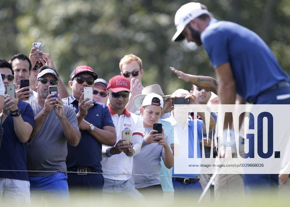 Fans holding mobile phones record Dustin Johnson on the second hole tee box in the final round of The Northern Trust golf championship at the Glen Oaks Club in Old Westbury, New York on August 27, 2017. Glen Oaks Club is hosting THE NORTHERN TRUST for the first time. NYP20170827111 JOHNxANGELILLO