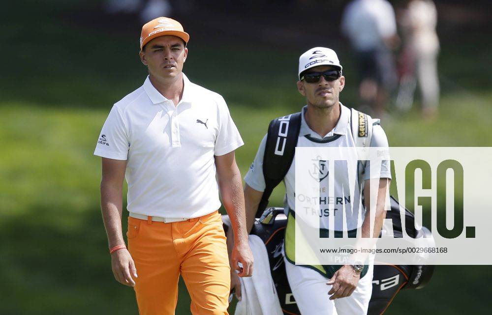 Rickie Fowler and caddie Joe Skovron walk to the 9th green in the final round of The Northern Trust golf championship at the Glen Oaks Club in Old Westbury, New York on August 27, 2017. Glen Oaks Club is hosting THE NORTHERN TRUST for the first time. NYP20170827102 JOHNxANGELILLO