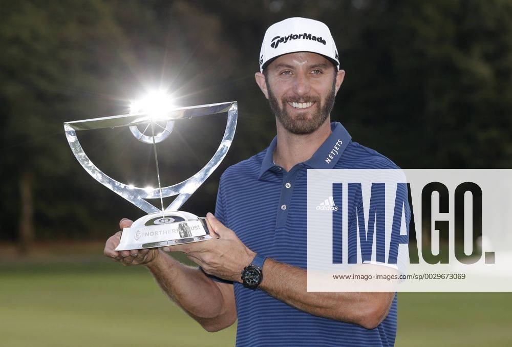 Dustin Johnson holds the championship trophy on the 18th green after he makes a birdie on the first playoff hole in his playoff against Jordan Spieth in the final round of The Northern Trust golf championship at the Glen Oaks Club in Old Westbury, New York on August 27, 2017. Johnson wins The Northern Trust with a score of 13 under par. NYP20170827118 JOHNxANGELILLO