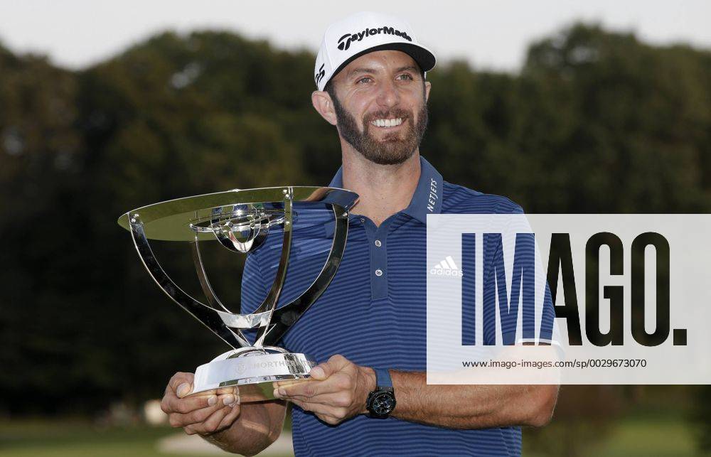 Dustin Johnson holds the championship trophy on the 18th green after he makes a birdie on the first playoff hole in his playoff against Jordan Spieth in the final round of The Northern Trust golf championship at the Glen Oaks Club in Old Westbury, New York on August 27, 2017. Johnson wins The Northern Trust with a score of 13 under par. NYP20170827119 JOHNxANGELILLO