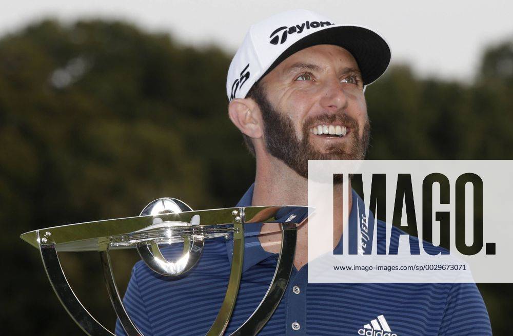 Dustin Johnson holds the championship trophy on the 18th green after he makes a birdie on the first playoff hole in his playoff against Jordan Spieth in the final round of The Northern Trust golf championship at the Glen Oaks Club in Old Westbury, New York on August 27, 2017. Johnson wins The Northern Trust with a score of 13 under par. NYP20170827120 JOHNxANGELILLO