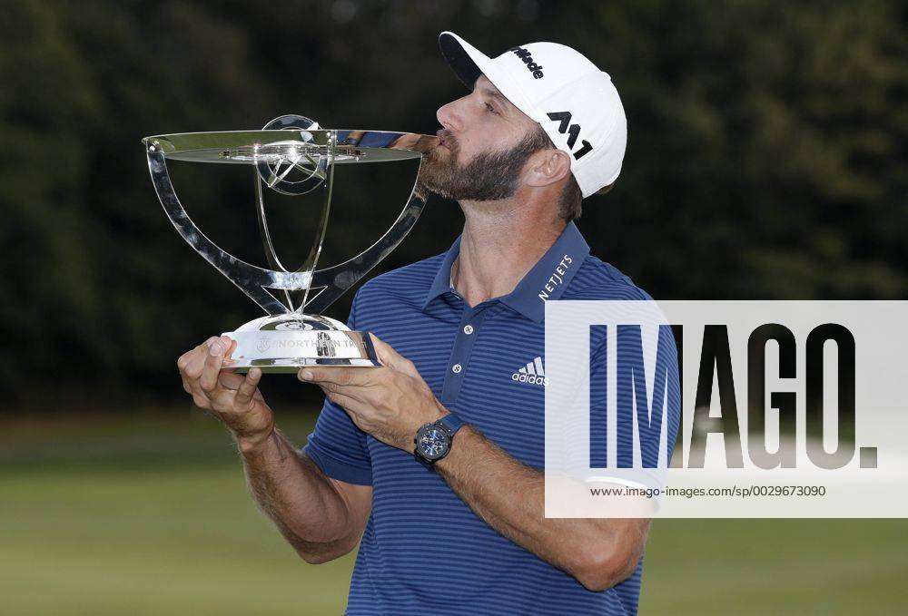 Dustin Johnson holds the championship trophy on the 18th green after he makes a birdie on the first playoff hole in his playoff against Jordan Spieth in the final round of The Northern Trust golf championship at the Glen Oaks Club in Old Westbury, New York on August 27, 2017. Johnson wins The Northern Trust with a score of 13 under par. NYP20170827116 JOHNxANGELILLO