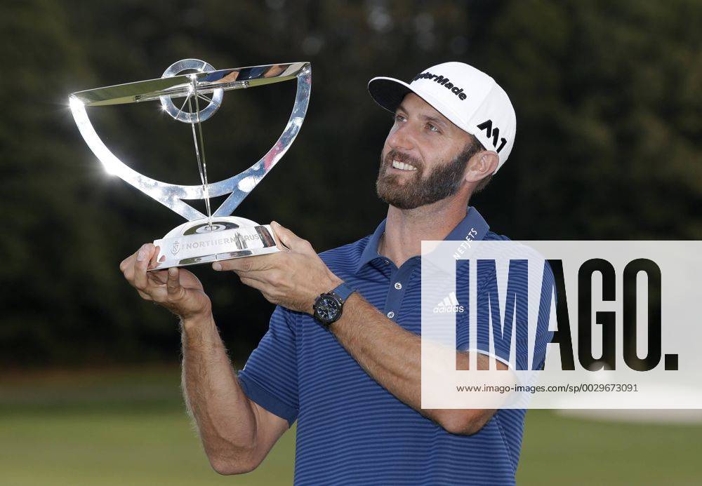 Dustin Johnson holds the championship trophy on the 18th green after he makes a birdie on the first playoff hole in his playoff against Jordan Spieth in the final round of The Northern Trust golf championship at the Glen Oaks Club in Old Westbury, New York on August 27, 2017. Johnson wins The Northern Trust with a score of 13 under par. NYP20170827117 JOHNxANGELILLO