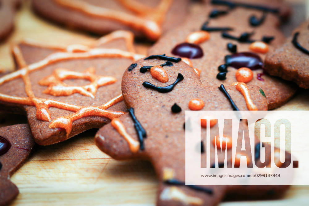 Children hand decorated gingerbread cookies Closeup on children hand decorated christmas gingerbread cookie man figurine