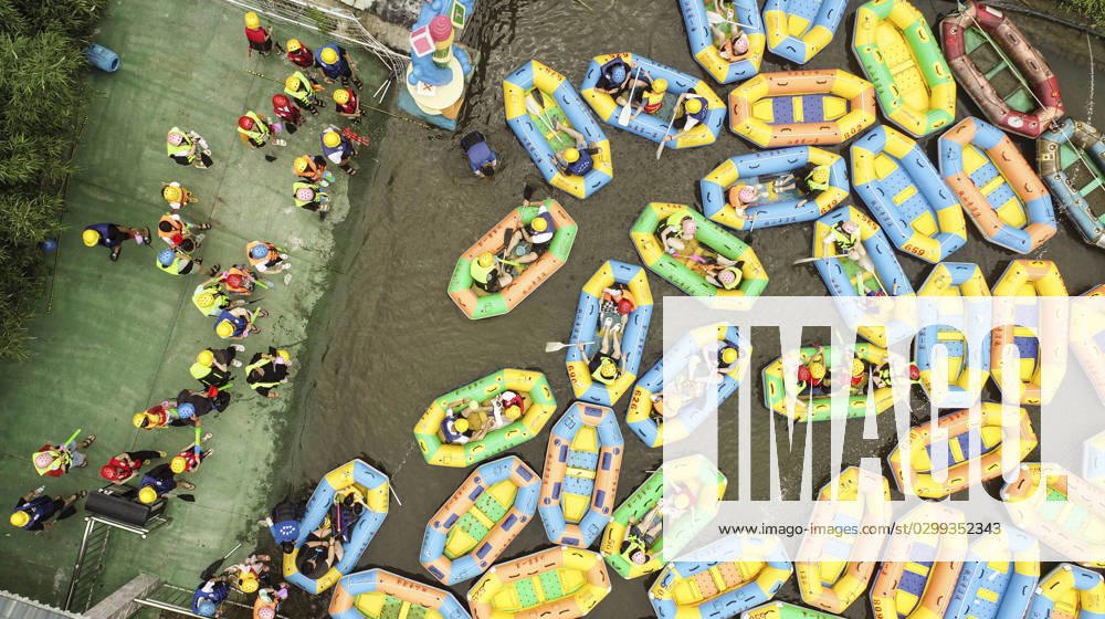 Tourists Experience River Rafting in Huai an HUAI AN, CHINA - JULY 16, 2023 - Tourists experience river rafting in the Tieshan Temple Forest Park in Huai an City, Jiangsu Province, China, July 16, 2023. Tieshan Temple Drift Road is 5.3 kilometers long, with a maximum drop of 128 meters. Huai an Jiangsu China