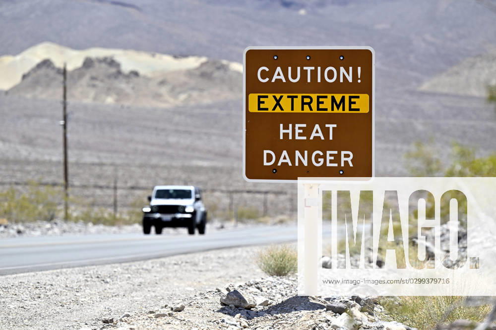Death Valley National Park, California, U.S. - A car passes a sign warning of extreme heat danger in Death Valley National Park, California on July 16, 2021. An excessive heat warning was issued for much of the Southwest United States. Climate models almost unanimously predict that heat waves will become more intense and frequent as the planet continues to warm. Death Valley National Park USA - ZUMAbk3_ 20230716_zaf_bk3_009