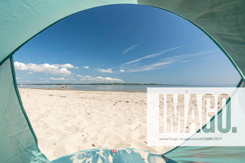 View from inside a tent onto beautiful white sand beach at the Baltic Sea at the Flensburger Förde in North Germany View from inside a tent onto beautiful white sand beach at the Baltic Sea at the Flensburger Förde in North Germany
