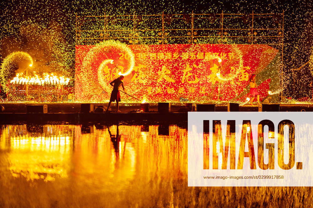 Intangible Cultural Heritage Performance in Nanjing, China NANJING, CHINA - JULY 22, 2023 - A beat iron flowers performance of an intangible cultural heritage project takes place on the evening of July 22, 2023 in Nanjing, Jiangsu province, China. Nanjing Jiangsu China