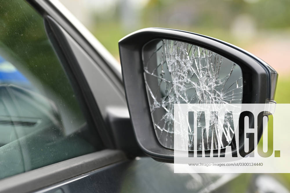 Vandalism, smashed wing mirror on a car