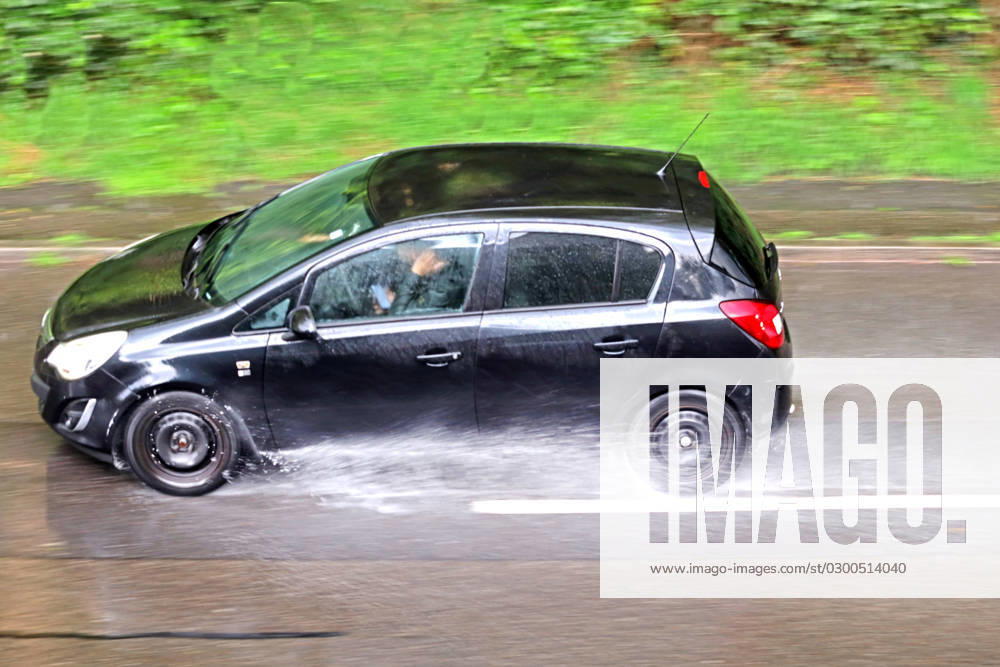 Dangerous road conditions during heavy rains Cars driving through sudden heavy rains and poor visibility