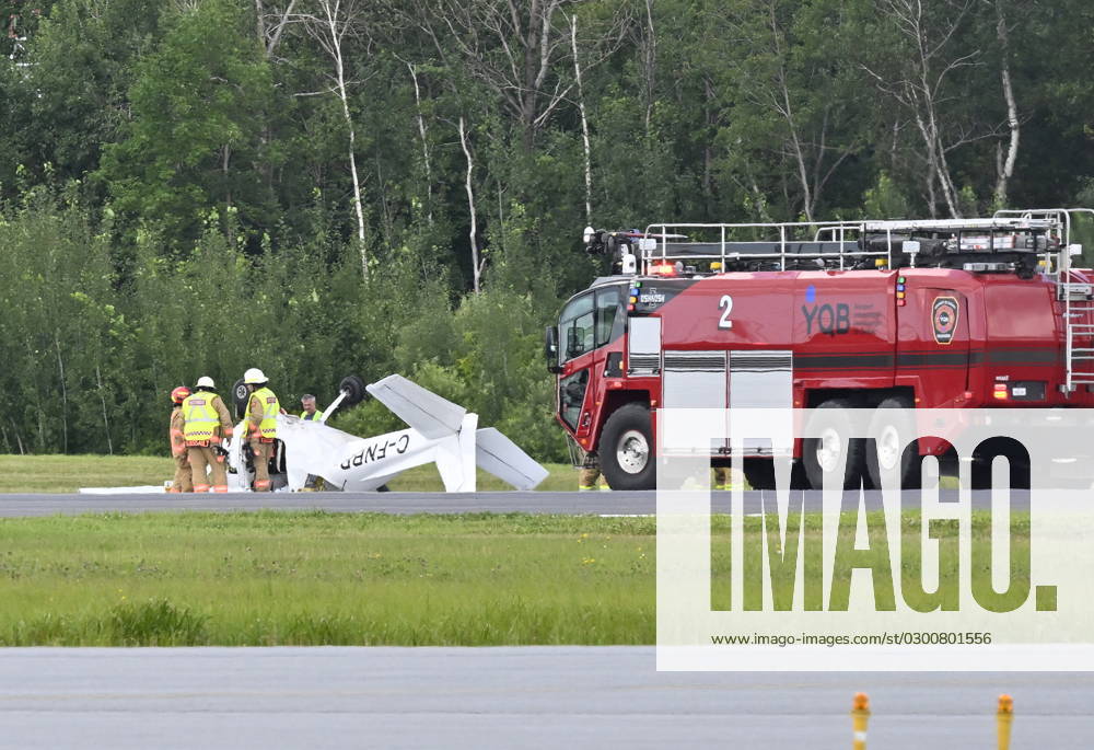 Firefighters look over a Cessna 152 aircraft after it crashed on landing at the Jean-Lesage Airport on Tuesday, Aug. 1, 2023 in Quebec City. One person was reported injured. QUEBEC CITY Canada - ZUMAc35_ 20230801_zaf_c35_021