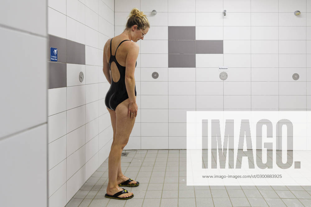 Subject woman under shower in public bath Bornheim Germany