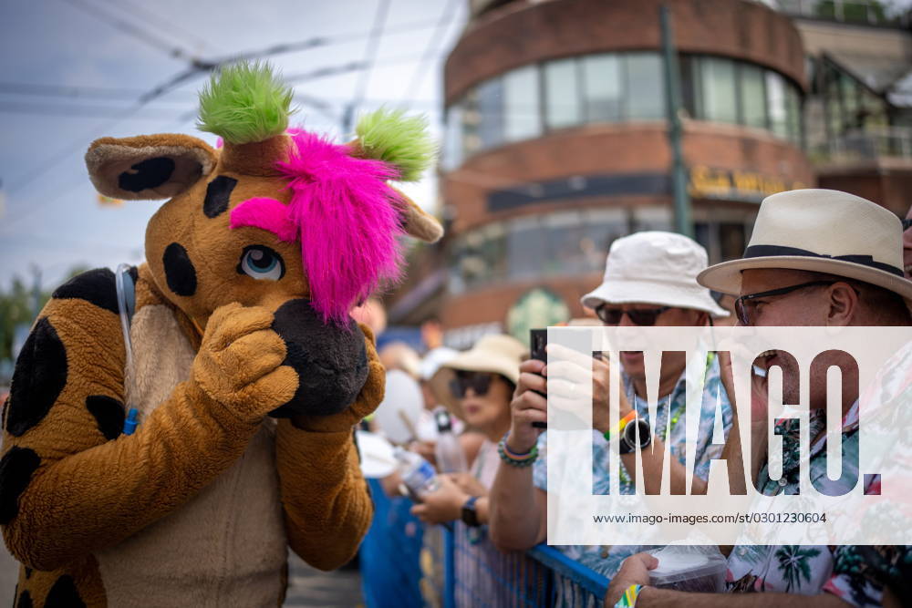 A person wearing a mascot suit, commonly referred to as a furry , giggles with a man in the crowd during the Pride Parade at English Bay in Vancouver, B.C., Sunday, Aug. 6, 2023. VANCOUVER CANADA - ZUMAc35_ 20230806_zaf_c35_014