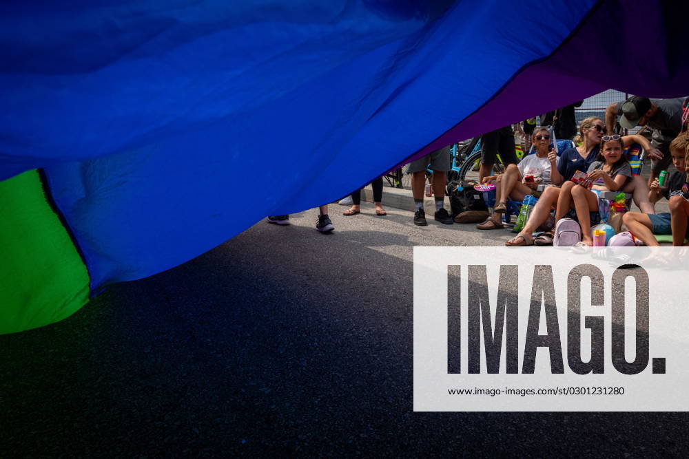 People watch as the Pride Parade passes at English Bay in Vancouver, B.C., Sunday, Aug. 6, 2023. VANCOUVER CANADA - ZUMAc35_ 20230806_zaf_c35_016