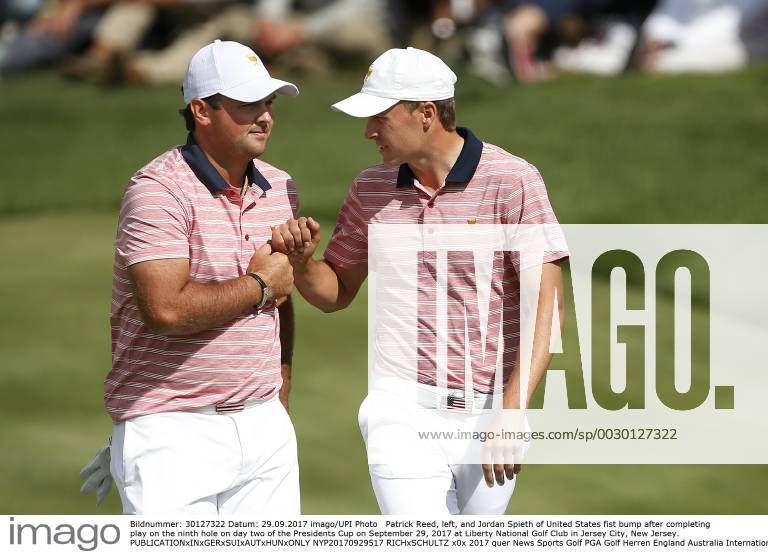 Patrick Reed, left, and Jordan Spieth of United States fist bump after completing play on the ninth hole on day two of the Presidents Cup on September 29, 2017 at Liberty National Golf Club in Jersey City, New Jersey. NYP20170929517 RICHxSCHULTZ