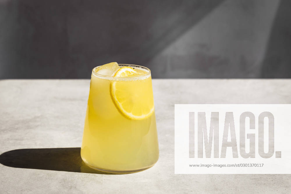 Homemade lemonade with ice and lemon slices in a glass. Homemade lemonade with ice and lemon slices in a glass.